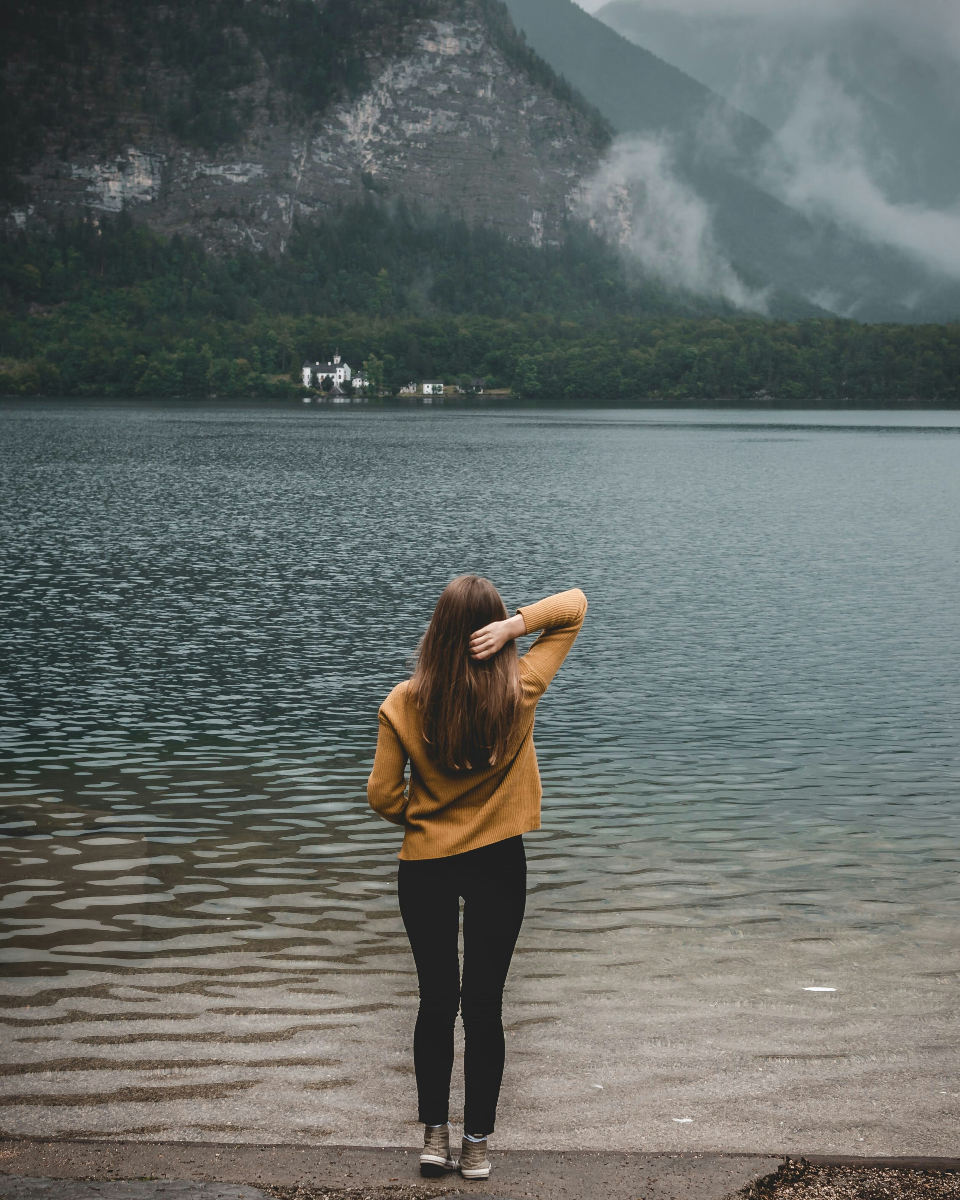 woman standing on shore during daytime